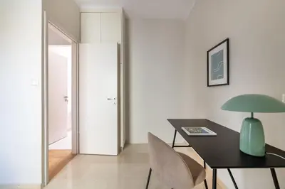 a dining room with a table and a green lamp at Luminous 3BR Apartment in Cholargos by UPSTREET in Athens