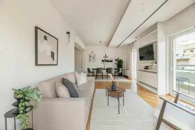 a living room with a couch and a table at Luminous 3BR Apartment in Cholargos by UPSTREET in Athens