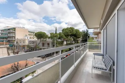 a balcony with a bench and a view of a city at Luminous 3BR Apartment in Cholargos by UPSTREET in Athens