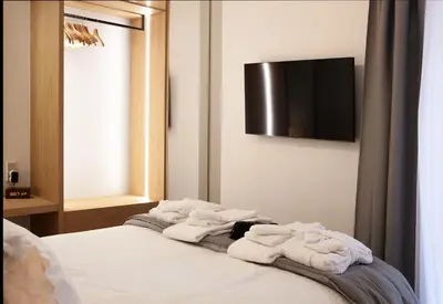 a room with a bed with towels on it at Aelia Luxury Properties - Executive Apartment in Athens