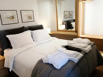 a bedroom with a bed with towels on it at Aelia Luxury Properties - Executive Apartment in Athens