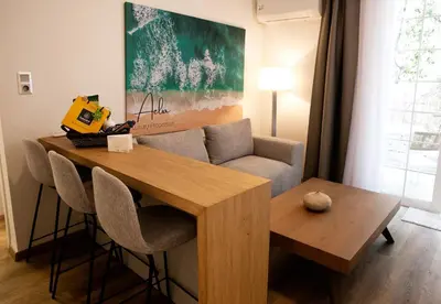 a living room with a table and a couch at Aelia Luxury Properties - Executive Apartment in Athens