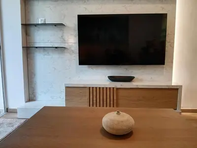 a vase sitting on a table in front of a tv at Aelia Luxury Properties - Executive Apartment in Athens