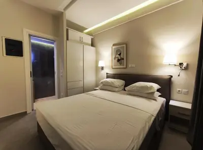 a bedroom with a large bed with white sheets and pillows at Athens Stay 15 in Athens