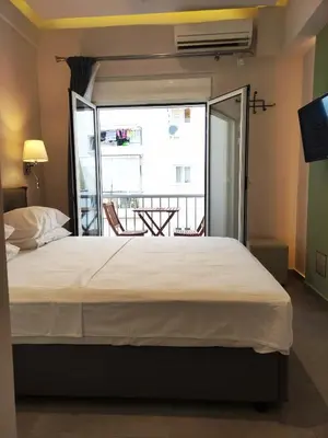 a bedroom with a large bed and a balcony at Athens Stay 15 in Athens