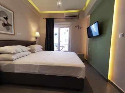 a bedroom with a bed with a tv on the wall at Athens Stay 15 in Athens