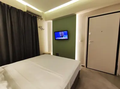 a bedroom with a bed and a tv on the wall at Athens Stay 15 in Athens