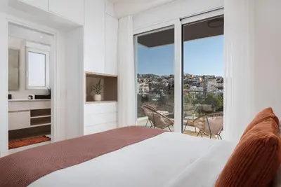 a bedroom with a bed and a large window at Athenian Riviera Elegant Residence in Athens