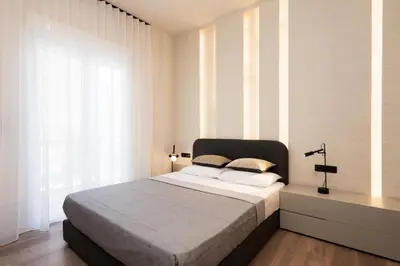 a bedroom with a bed and a large window at Athens City Modern Apartments in Athens