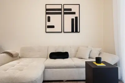 a living room with a white couch and a table at Athens City Modern Apartments in Athens