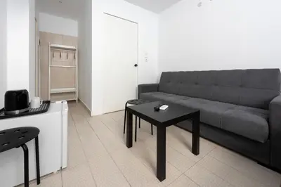 a living room with a couch and a table at Ati-Key Residence in Athens