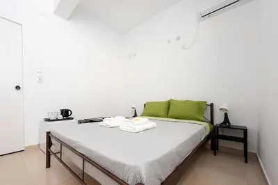 a bedroom with a bed with towels on it at Ati-Key Residence in Athens