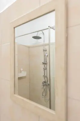 a shower in a bathroom with a mirror at Ati-Key Residence in Athens