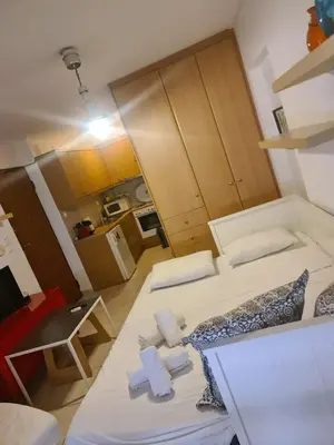 a small room with two beds and a kitchen at Cute Apartment Next To Acropolis Museum in Athens