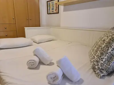 a bed with two rolled towels on it at Cute Apartment Next To Acropolis Museum in Athens
