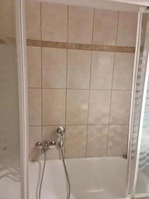 a shower with a hose in a bathroom at Cute Apartment Next To Acropolis Museum in Athens
