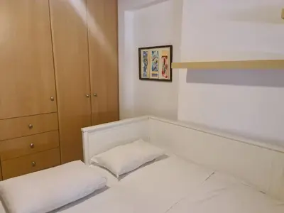 a small bedroom with a bed and a cabinet at Cute Apartment Next To Acropolis Museum in Athens