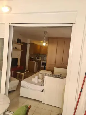 a view of a room with a bed and a mirror at Cute Apartment Next To Acropolis Museum in Athens