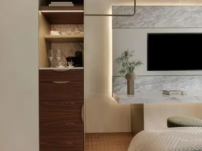 a bedroom with a bed and a tv on a wall at Anthology of Athens, The Leading Hotels of the World in Athens