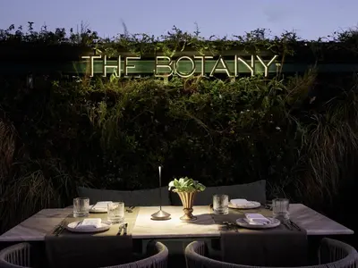 a table with a sign that says the botany on it at Anthology of Athens, The Leading Hotels of the World in Athens