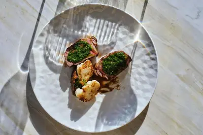 a plate of food with broccoli on a table at Anthology of Athens, The Leading Hotels of the World in Athens