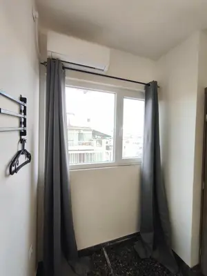 a window with black curtains in a room at Liberal Mini Rooms & Suites in Athens
