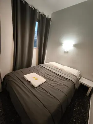 a bedroom with a bed with two towels on it at Liberal Mini Rooms & Suites in Athens