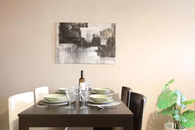 a dining room table with a bottle of wine on it at Modern 2BD apartment next to Acropolis in Athens