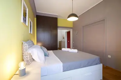 a bedroom with a large bed in a room at Modern 2BD apartment next to Acropolis in Athens