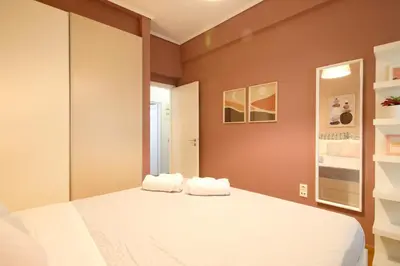 a bedroom with a bed with two towels on it at Modern 2BD apartment next to Acropolis in Athens
