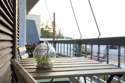 a glass bowl with a plant on a wooden table on a balcony at Modern 2BD apartment next to Acropolis in Athens
