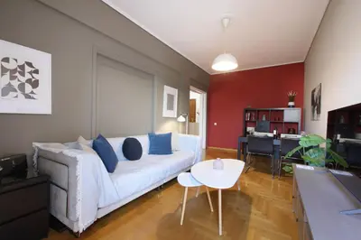 a living room with a white couch and a table at Modern 2BD apartment next to Acropolis in Athens