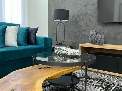 a living room with a blue couch and a table at Acropolis Signature Apartment in Athens