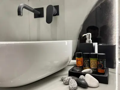 a bathroom with a sink and a white tub and a sink at Acropolis Signature Apartment in Athens