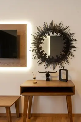 a mirror on a wall next to a table with a tv at Acropolis Signature Apartment in Athens