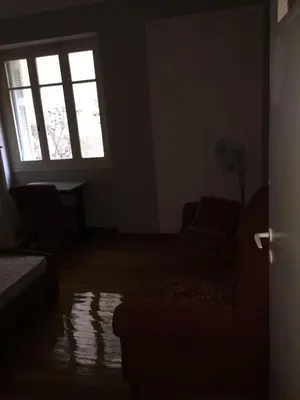 a living room with a couch and a window at Relax & Enjoy in Athens