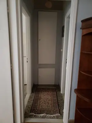 an empty hallway with a door and a rug at Relax & Enjoy in Athens