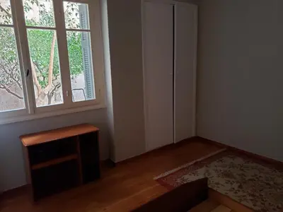 an empty room with a window and a table at Relax & Enjoy in Athens