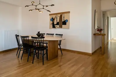 a dining room with a table and chairs at Athenian Songs - 3BR Penthouse with Acropolis Views in Athens