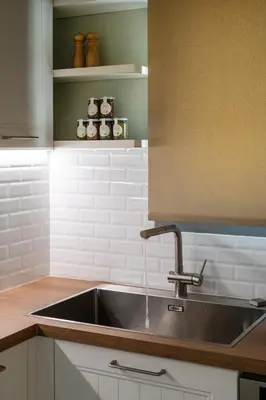 a kitchen sink with water coming out of it at Athenian Songs - 3BR Penthouse with Acropolis Views in Athens