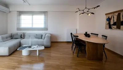 a living room with a couch and a table at Athenian Songs - 3BR Penthouse with Acropolis Views in Athens