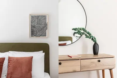 a bedroom with a bed and a table with a mirror at Acropolis Sunlight 2BR Apartment by UPSTREET in Athens