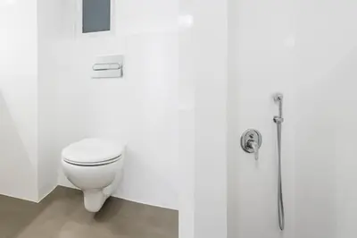 a white bathroom with a toilet and a shower at Acropolis Sunlight 2BR Apartment by UPSTREET in Athens
