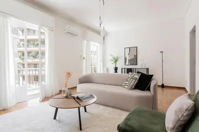 a living room with a couch and a table at Acropolis Sunlight 2BR Apartment by UPSTREET in Athens