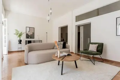 a living room with a couch and a table at Acropolis Sunlight 2BR Apartment by UPSTREET in Athens