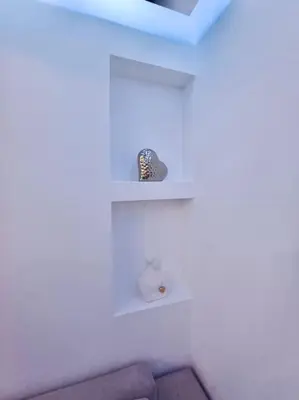 a room with white shelves in a white wall at Varkiza Seaside 2BD Apartment in Varkiza
