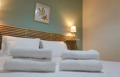 a bed with four towels stacked on top of it at Callista apartment in Athens