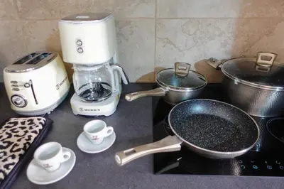 a kitchen counter with a coffee maker and a blender at Callista apartment in Athens