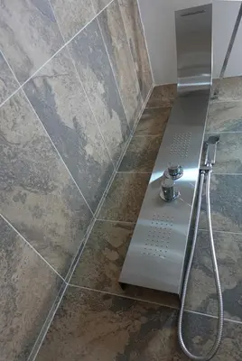 a shower in a bathroom with a tile floor at Callista apartment in Athens