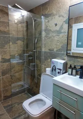 a bathroom with a shower and a toilet and a sink at Callista apartment in Athens